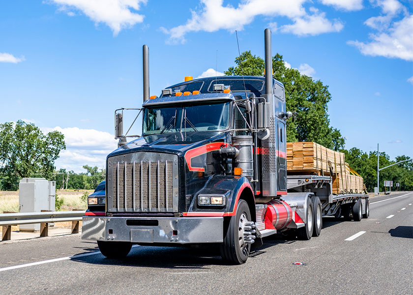 Black Semi Truck Black Semi with full load of Wood